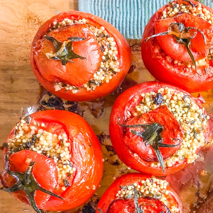 five baked tomatoes stuffed with millet and herbs