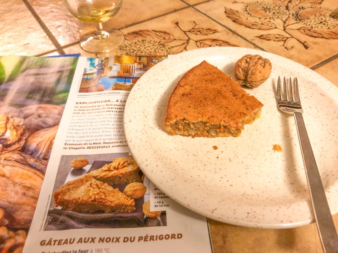 A magazine featuring a French walnut cake recipe next to a walnut cake slice.