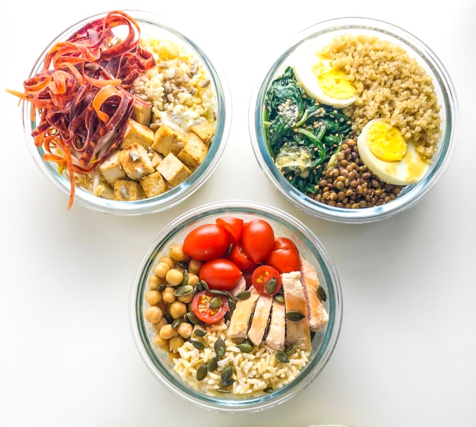 three round nourish bowls packed with different veggies, grains and protein