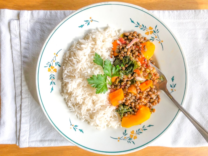 a plate with half rice, half lentils with vegetables