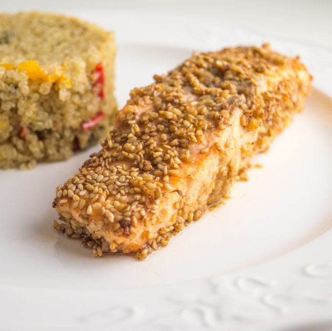 image of a salmon fillet with sesame seeds, with quinoa side on the background