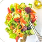 bowl with a low fodmap salad and dressing in a small bowl