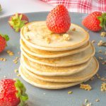 pile of pancakes with strawberries on a plate
